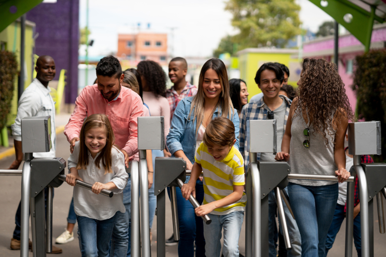 Happy group of people arriving at an amusement park