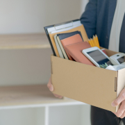 Stressful businessman packing a box for quit a job.