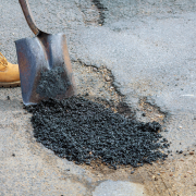 Laying new asphalt, covering the pit, very bad quality road with hole in asphalt