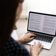 Focused young businesswoman working on electronic documents